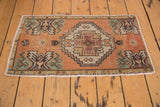 Vintage distressed Oushak rug mat corner, seafoam green geometric spandrels, primitive buds.