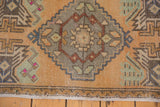 Distressed Oushak rug detail: diamond medallion with playful comb and pinwheel patterns.