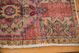 Distressed Oushak rug detail: worn pile, geometric blush and sand motifs, intact selvage.