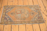 Vintage Distressed Oushak rug with scalloped apricot medallion and slate blue spandrels.