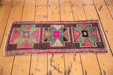 Geometric medallion from the distressed Oushak rug in pink, mint green, and charcoal tones.