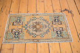 Distressed Oushak rug corner, germinating plant motif, in oxidized green, dusty gold.