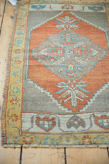 Vintage Oushak rug mat with serrated diamond design in burnt orange, beige, and light blue.