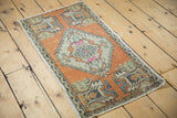 Distressed vintage Oushak mat, diamond medallion, plant motif, faded burnt orange, foundation wear.