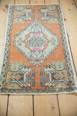 Distressed Oushak rug detail, faded orange and ivory diamond contour with visible even wear.
