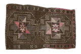 Distressed vintage Oushak rug mat, geometric medallions in dark brown, silver, and pink.