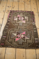Geometric distressed Oushak rug with scrolling patterns, bright bubble gum pink and chocolate brown.