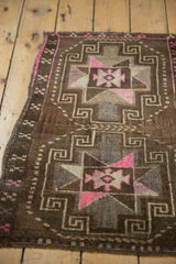 Distressed Oushak geometric patterns in chocolate brown, oxidized silver, and bright pink.