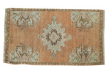 Distressed vintage Oushak rug with pale terracotta, scalloped medallion, mint green motifs, 1'7
