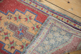 Textured pile and hand-knotted reverse of the vintage distressed Oushak rug.