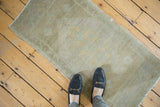 Distressed Oushak rug, showing low pile wear and faded beige, sand, and pale seafoam tones.