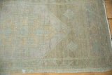 Vintage Distressed Oushak rug corner with low pile texture, subtle beige and pale green patterns.