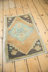 Distressed Oushak rug mat with faded terracotta, blue geometric medallion, and low pile.