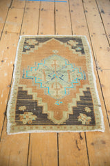 Stepped chocolate brown spandrel, worn pile, and fringe of this distressed Oushak rug.