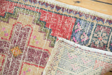 Distressed Oushak rug detail: worn pile, visible knot heads, and hand-knotted reverse.