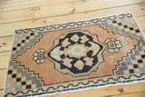 Vintage distressed Oushak rug corner with checker spandrel pattern and subtle pile wear.