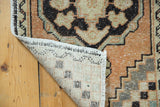 Hand-knotted reverse of this Vintage Distressed Oushak rug, showing its secured fringe and pile.