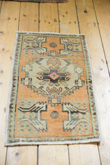 Secured left edge of the distressed tangerine orange Oushak rug, showing subtle wear.