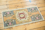 Distressed Oushak rug corner with worn pile, colorful geometric motifs, and secured edge.