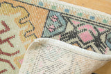 Distressed hand-knotted Oushak rug texture, showing faint foundation and muted colors.