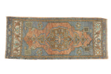 Vintage distressed Oushak runner with terracotta medallion on an abrashed slate blue field.