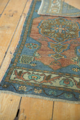 Short fringe and distressed low pile on a terracotta and slate blue Oushak runner.