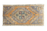 Vintage Oushak rug mat, geometric medallion in distressed dark gold and slate gray.