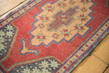 Distressed Oushak geometric medallion and cochineal red field, with cobalt blue lines and even wear.