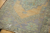 Distressed vintage Oushak rug close-up: even wear, foundation showing, pistachio green, apricot gold.