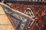 Vintage Engelas rug corner, Herati motif in brick red rust, navy, and light fringe tatter.