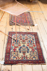 Worn low pile and red floral motifs on corner of vintage American Sarouk rug.