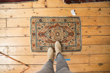Haji Jalili Tabriz rug's intricate medallion and vine borders in dusty rust and navy.