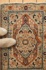 Haji Jalili Tabriz rug with intricate scalloped medallion, delicate vines, dusty rust, ivory, blue.