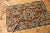 Tattered edges and intricate border patterns of the antique Haji Jalili Tabriz rug.