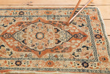 Meandering vine and barber pole style patterns on the layered borders of an antique Tabriz rug.