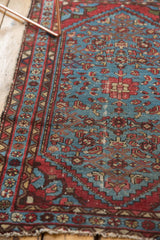 Vintage Malayer rug with aqua blue field, red geometric border, and tattered end.