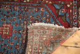 Vintage Malayer rug: aqua blue pile, red Herati motifs, abrash, tattered fringe, and foundation.