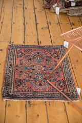 Classic Sarouk style floral spandrels and border in brick red and navy blue.