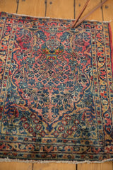 Vintage Sarouk rug's tree-of-life motif featuring a potted vase, blush, and navy vinery.