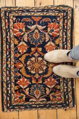 Vintage Borchalou rug showing navy, gold, and orange scrolling palmette motifs with light tatter on edges.