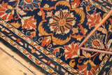 Hand-knotted Borchalou rug detail with navy blue, gold, rust scrolling motifs and border.