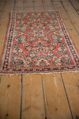 Repeating floral bouquets across the cherry red field of the vintage Sarouk runner.