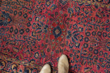 Vintage Persian Sarouk rug, low pile dusty raspberry field, dense navy blossoming plants.