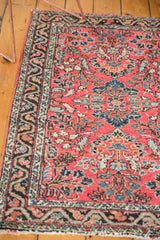 Corner detail of vintage Dargezine rug, with dusty brick red floral field and distinctive border.