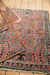 Blush floral field, navy border, and light fringe tatter of the vintage Dargezine rug.