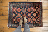 Vintage Lilihan rug with Veramin floral motif, navy, blush, madder, and subtle birds.