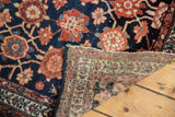 Detail of hand-knotted Lilihan rug: navy blue, red Veramin floral pattern and tight reverse weave.