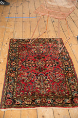 Corner of vintage Dargezine runner, Sarouk style floral field, deep navy border, and fringe.