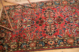 Hand-knotted Sarouk style floral field, with rich brick red and blue tones, secure edge.
