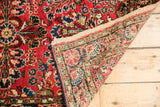 Vintage Dargezine runner's hand knotted construction, dusty brick red floral pile, and woven back.